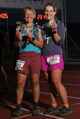 Runners holding medals