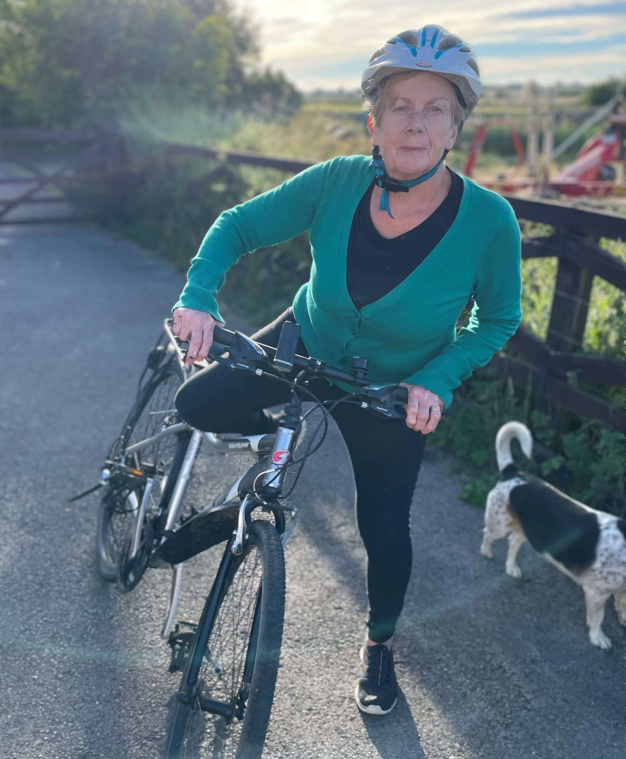woman getting on bicycle