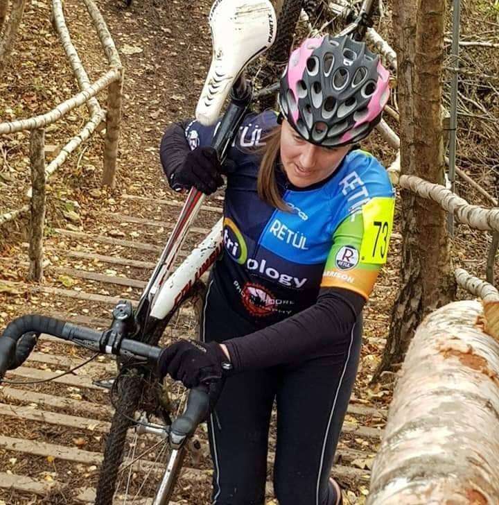 Lady carrying cyclocross bike. She had suffered with leg pain with pains and needles